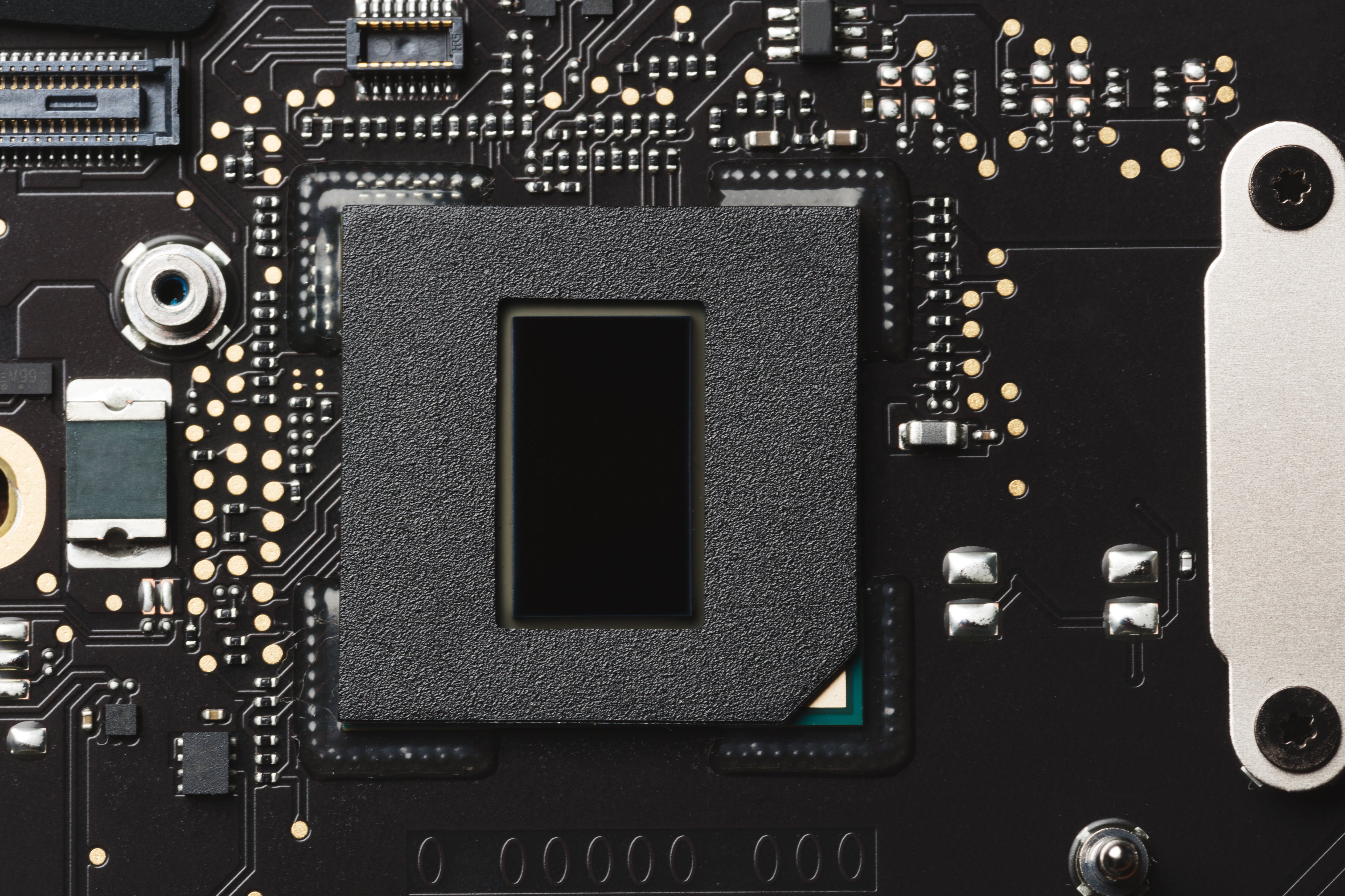 A picture of a computer motherboard showing the circuits and connection points