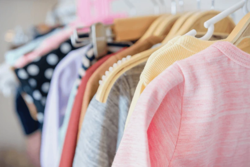 A rack of colorful children's clothing featuring over 10 garments